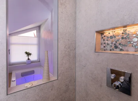 Dunkel getönte, raumhohe Glasscheibe im Referenzbad vom Handwerksunternehmen Prehn & von Hoeßlin GmbH & Co. KG.