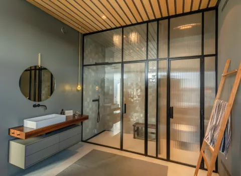 Walk-In-Dusche und edler Waschtisch aus Holz im Penthouse-Referenzbad vom Handwerksunternehmen Prehn & von Hoeßlin GmbH & Co. KG.