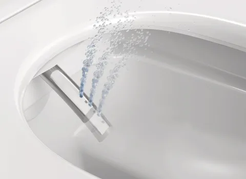 Reinigungsdüse eines Dusch-WC SensoWash D-Neo während der Wasserfunktion.